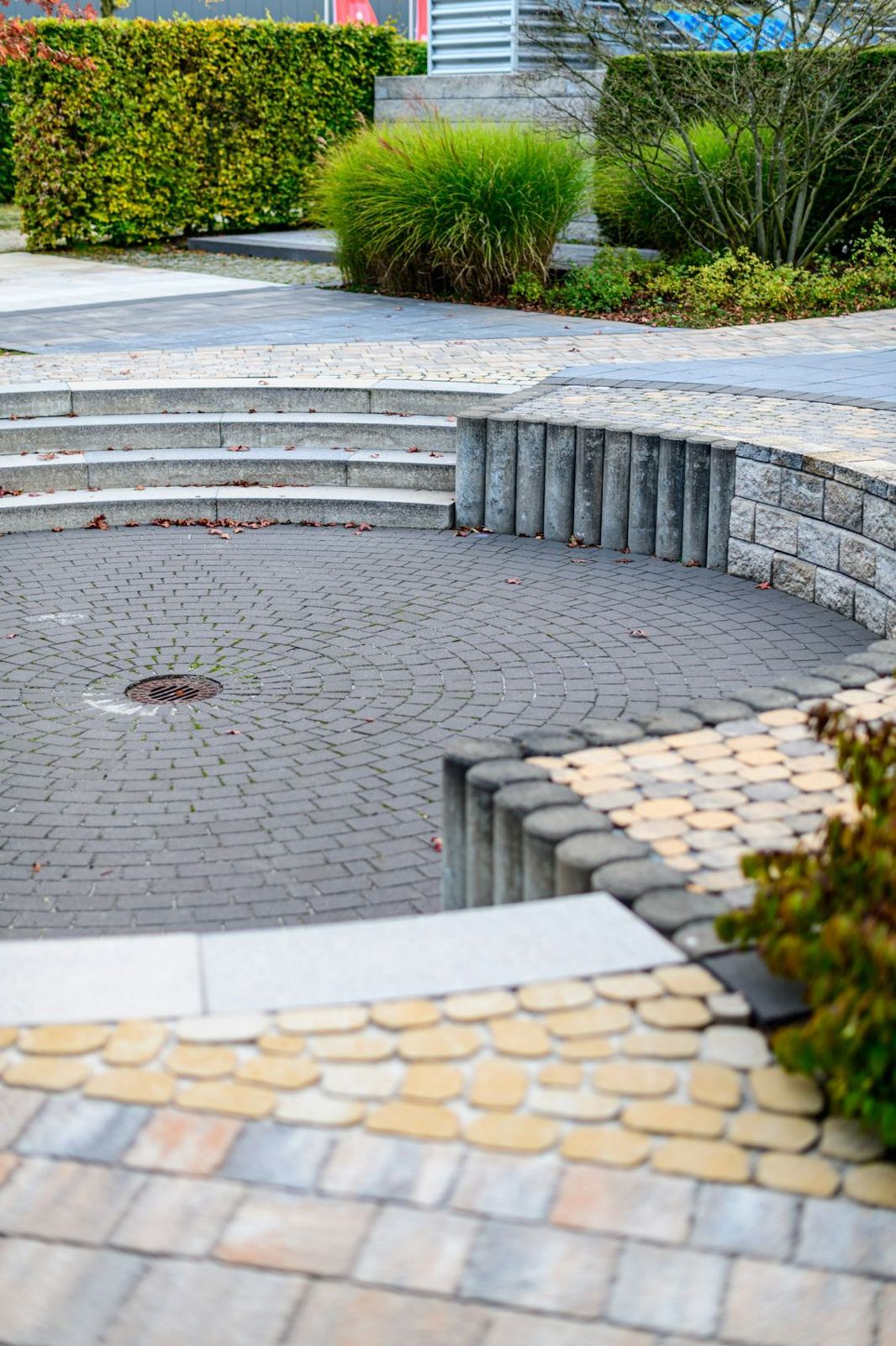 Paver steps leading down to a circular patio